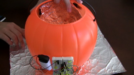 This photo shows the piece of aluminum foil mounted inside the plastic Jack-O-Lantern model.