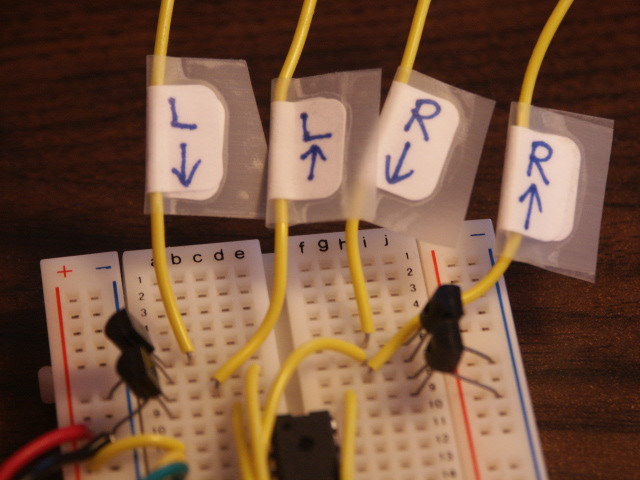 Photo of the four 2N7000 transistors wired up at the top of the NerdKits breadboard
