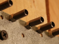 This shows several steel slugs with magnets attached.  The magnets attach to the non-hollowed end, to let the magnetic flux from the magnet flow through the steel.