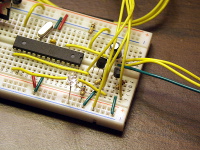 The microcontroller outputs audio data through the filter near the top right of this photo.  Also visible are the two BJTs that provide level shifting for caliper clock and data, as well as the LED that provides simple voltage regulation to power the calipers.