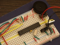 The breadboard with the piezo element to create the sound.